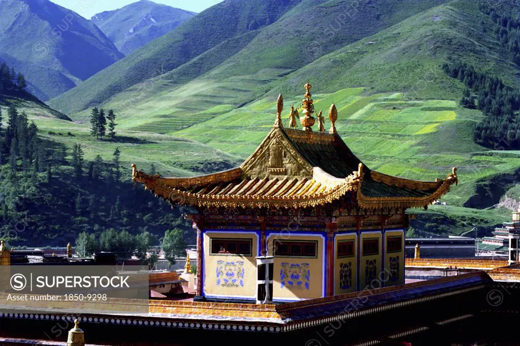 China, Gansu, Xiahe, Golden Roofed Labrang Monastery And Green Hillsides Beyond