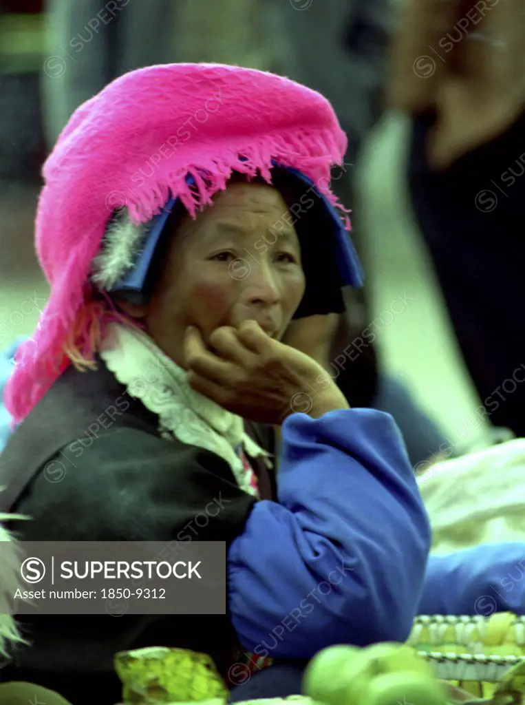 China, Yunnan, Zongdian, Portrait Of A Female Street Vendor Wearing A Pink Hat