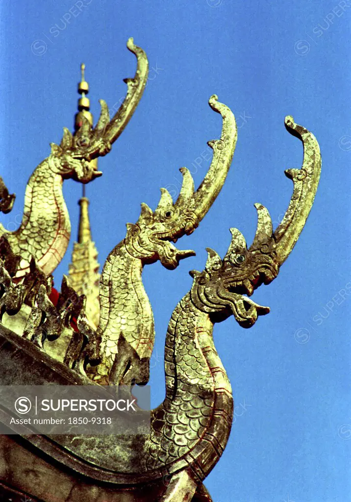 Laos, Savannakhet, Wat Sainyamungkhun. Golden Roof Detail Of Guardians In The Form Of Dragons Used To Keep Evil Spirits Away