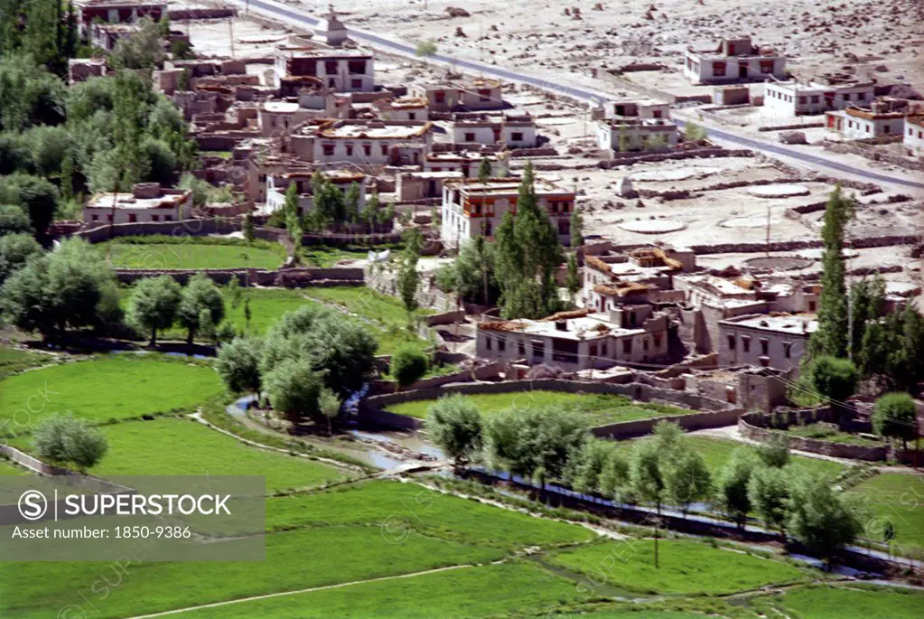 India, Ladakh, View Over Village Houses With Water Run Along The Edge Of Cultivated Fields Providing The Lifeblood For The Valley