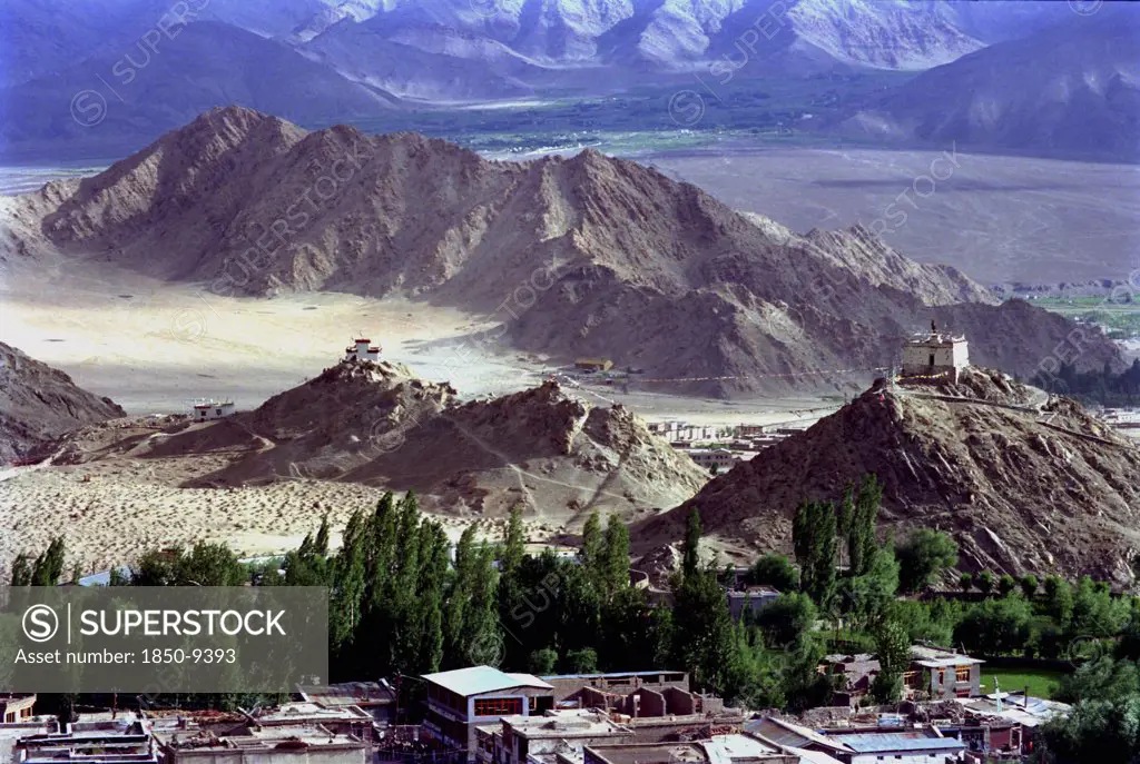 India, Ladakh, Leh, View Toward Distant Hilltop Temples On The Outskirts Of The Town Against A Backdrop Of Mountains