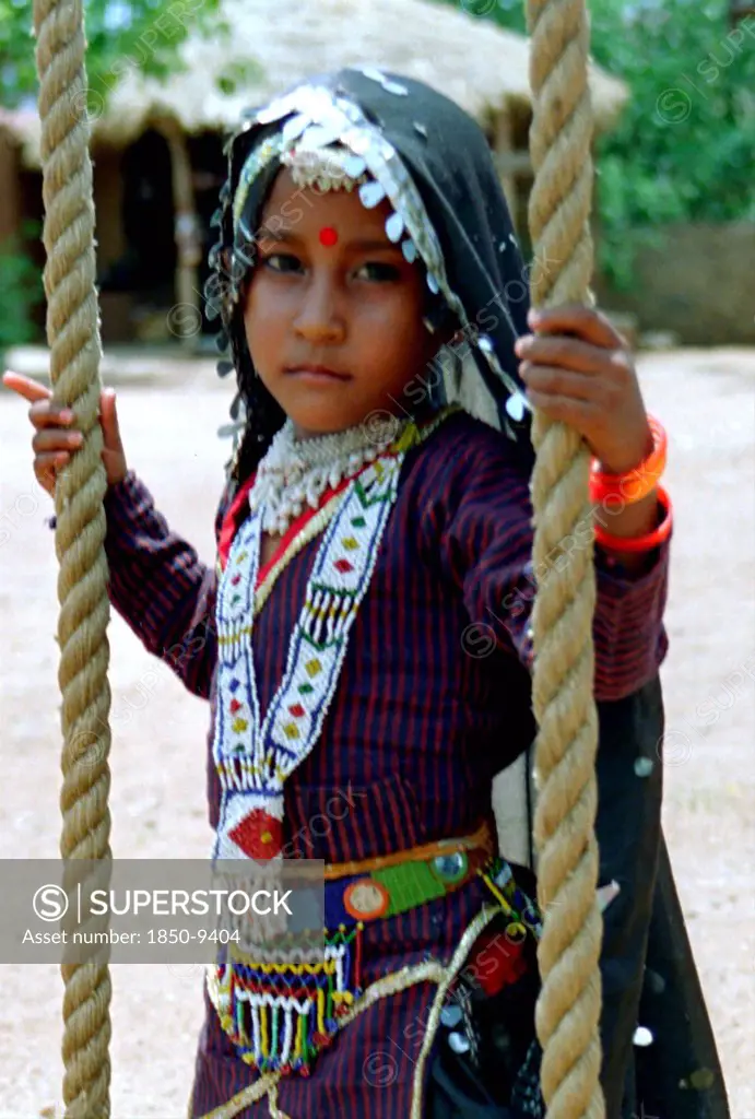 India, Rajasthan, Udaipur, Portrait Of A Young Girl Playing On A Rope Swing