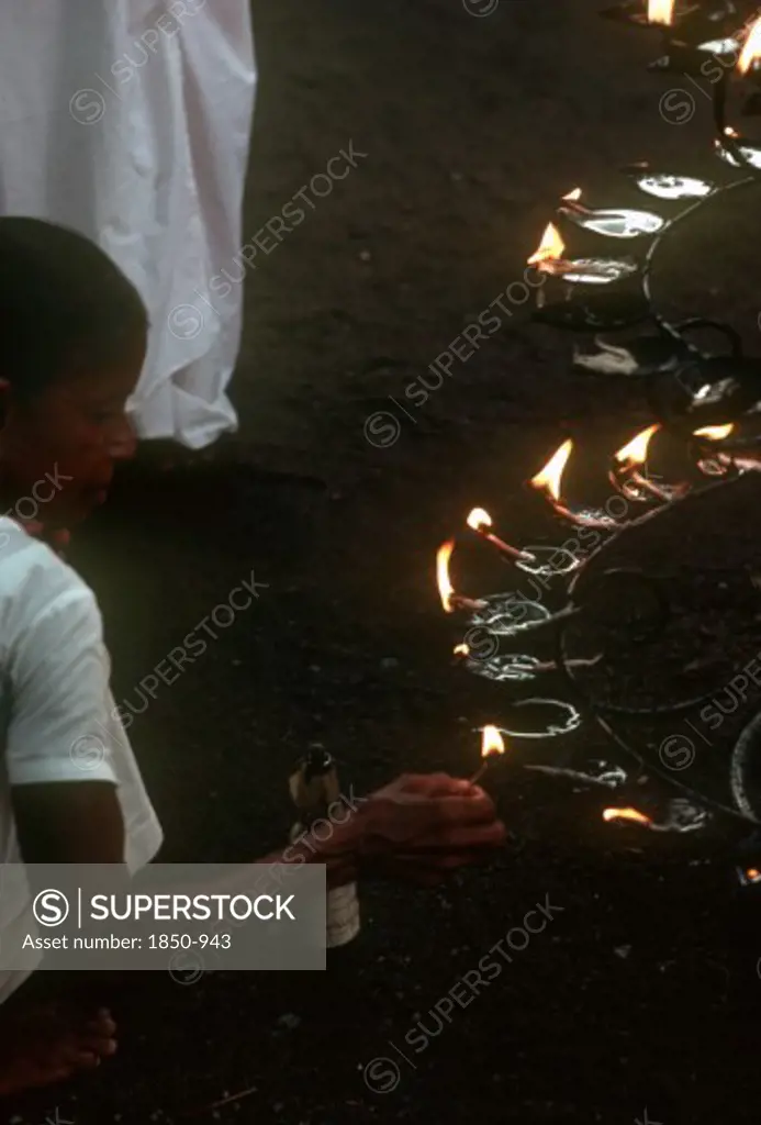 Sri Lanka, Anuradhapura, People Lighting Lamps During Wessac