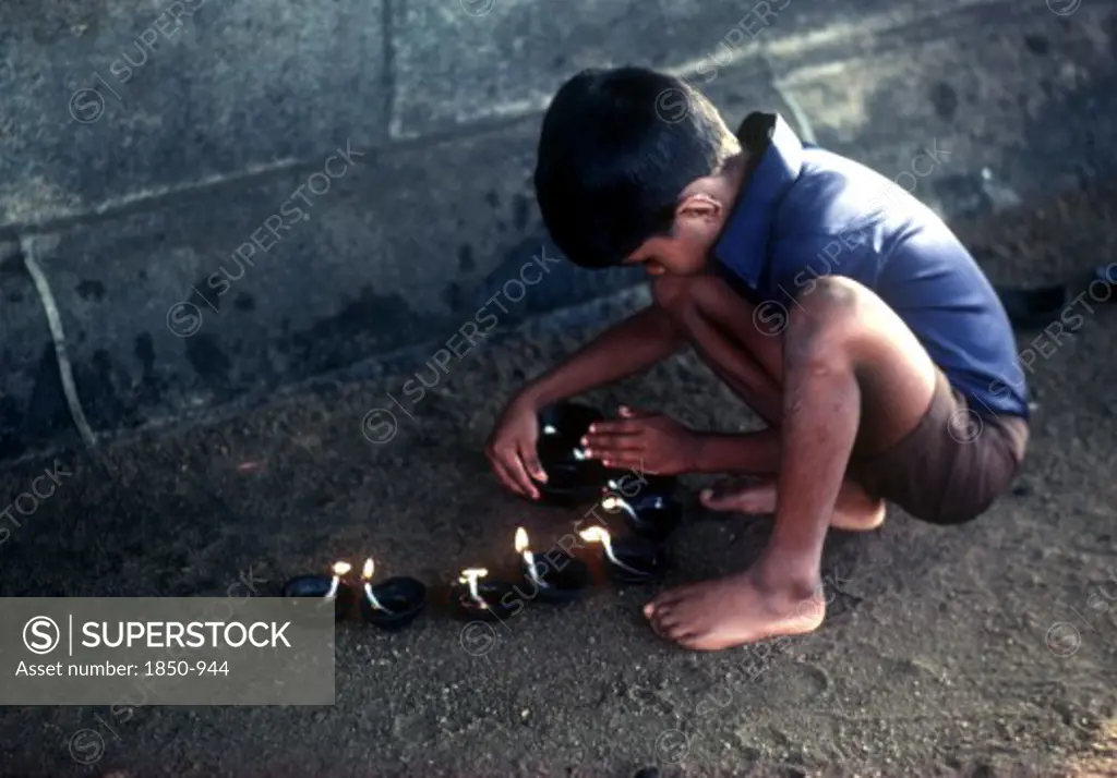 Sri Lanka, Religion, Young Boy Lighting Lamps For Wessac