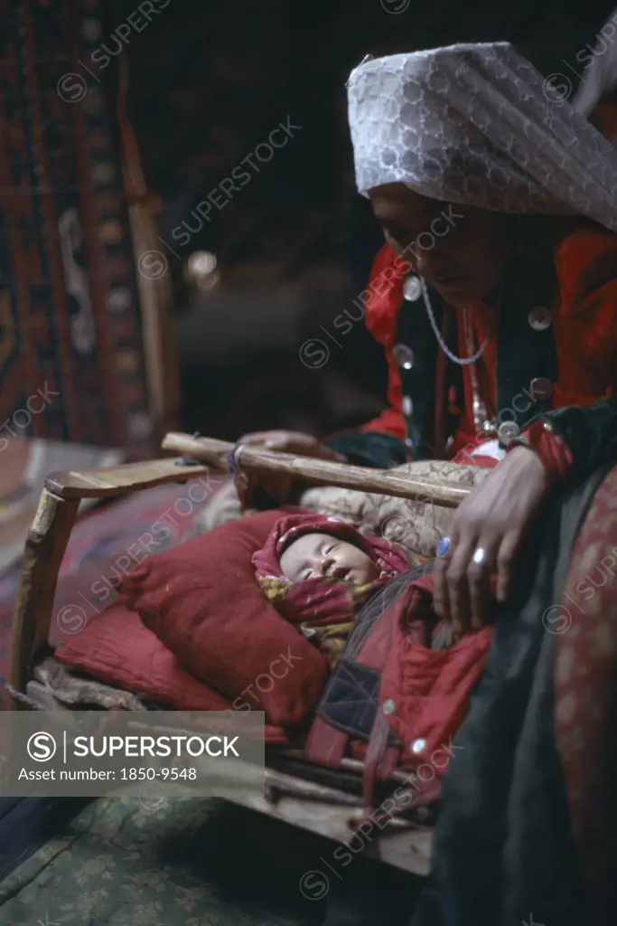 Afghanistan, People, Kirghiz Woman With Baby Inside Yurt.