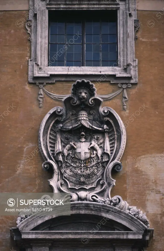 Italy, Lazio, Rome, Piazza Del Campidoglio.  Exterior Detail Of The Palazzo Senatorio Or Senators Palace With Carved Stone Heraldic Coat Of Arms.