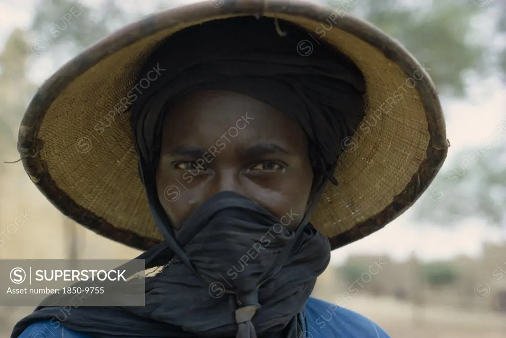 Nigeria, People, Women, Portrait Of A Fulani Woman Wearing A Hat With A Scarf Covering Her Mouth.