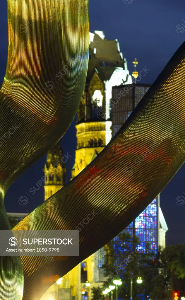 Germany, Berlin, Detail Of Illuminated Wavy Metal Sculpture Entitled Berlin With The Kaiser Wilhelm Gedachtniskirche Behind