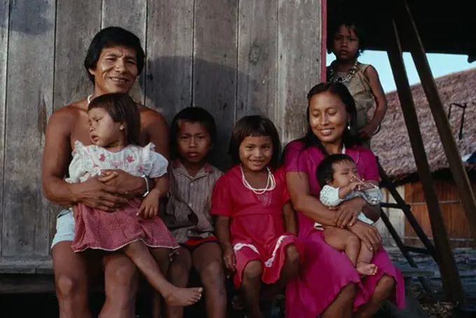 Colombia, North West Amazon, Tukano Indigenous People, Makuna Family - Venancio One Of Headman Bosco' Sons  With His Wife And Five Children Outside Their Recently Constructed Small Family Home. Venancio Is The Teacher In The Local Makuna School   Makuna Indian North Western Amazonia  Cassava American Colombian Columbia Hispanic Indegent Latin America Latino Male Men Guy South