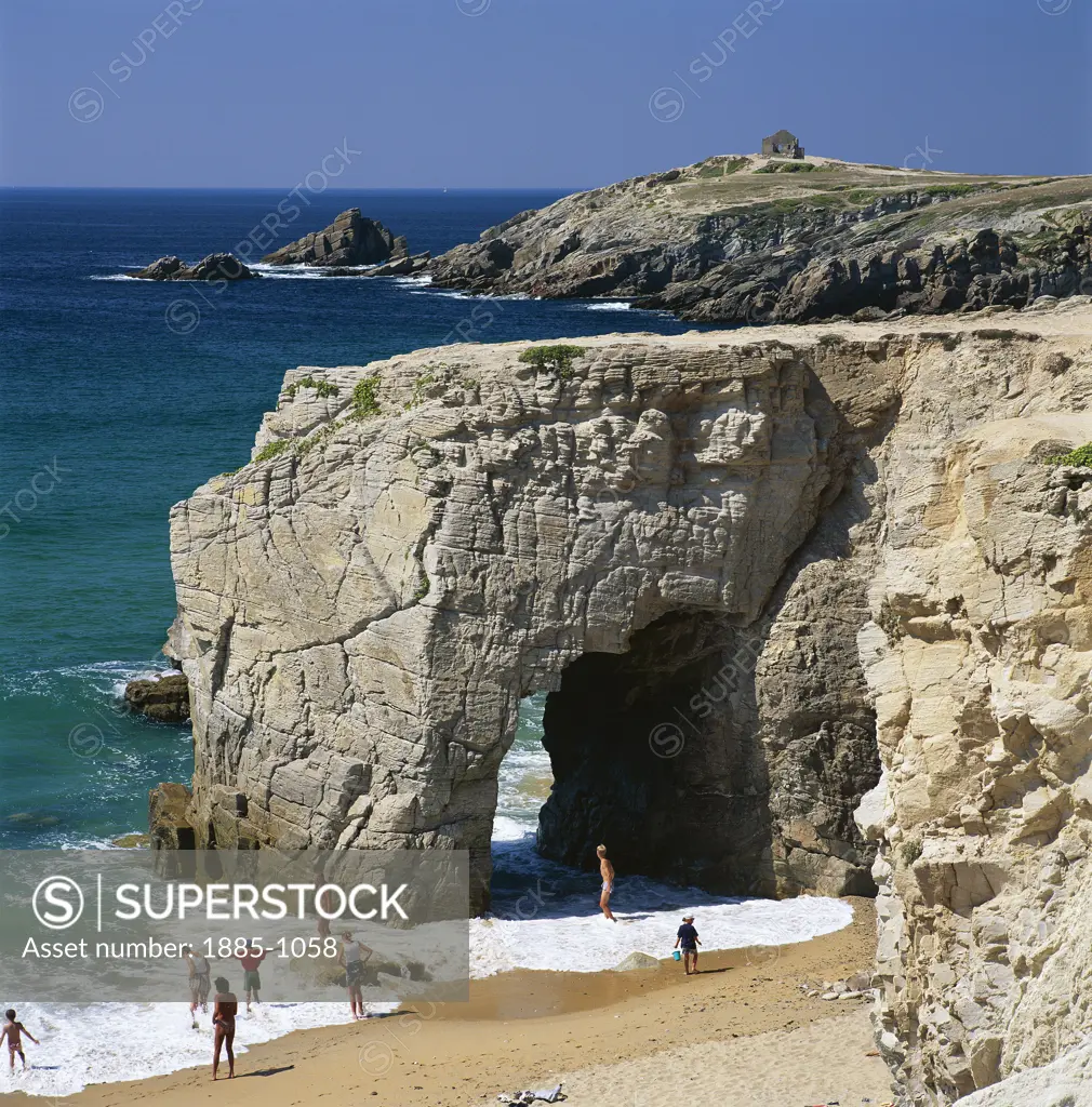 France, Brittany, Quiberon Peninsula, Beach with natural rock arch in sea