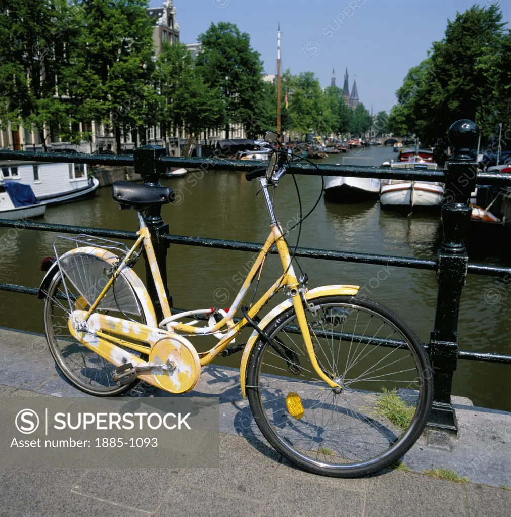 Netherlands, Noord Holland Province, Amsterdam, Yellow bicycle by canal