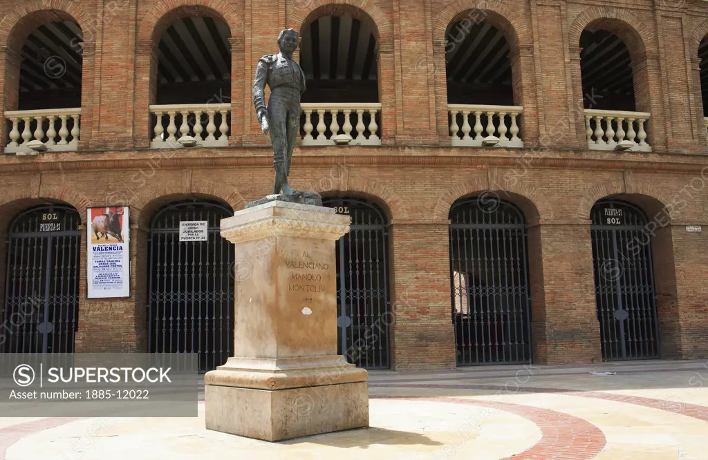 Spain, Valencia Region, Valencia, Plaza de Toros - exterior of bullring with statue and poster