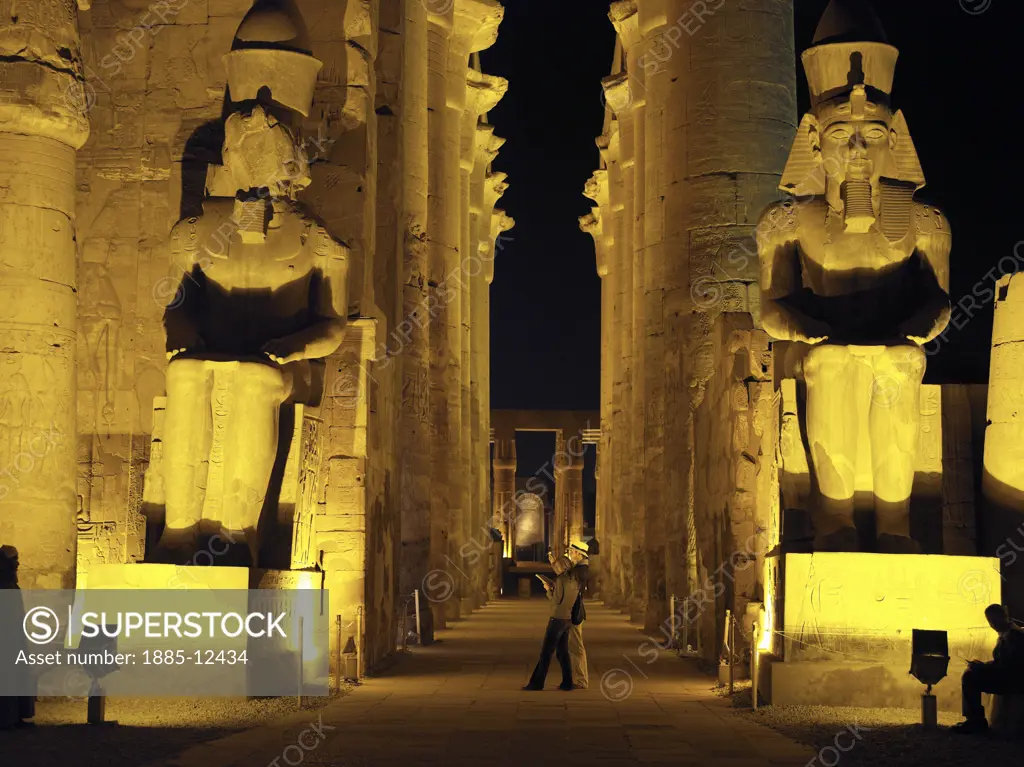 Egypt, , Luxor, Karnak - floodlit statues flanking Colonnade of Amenhotep III at Temple of Amun