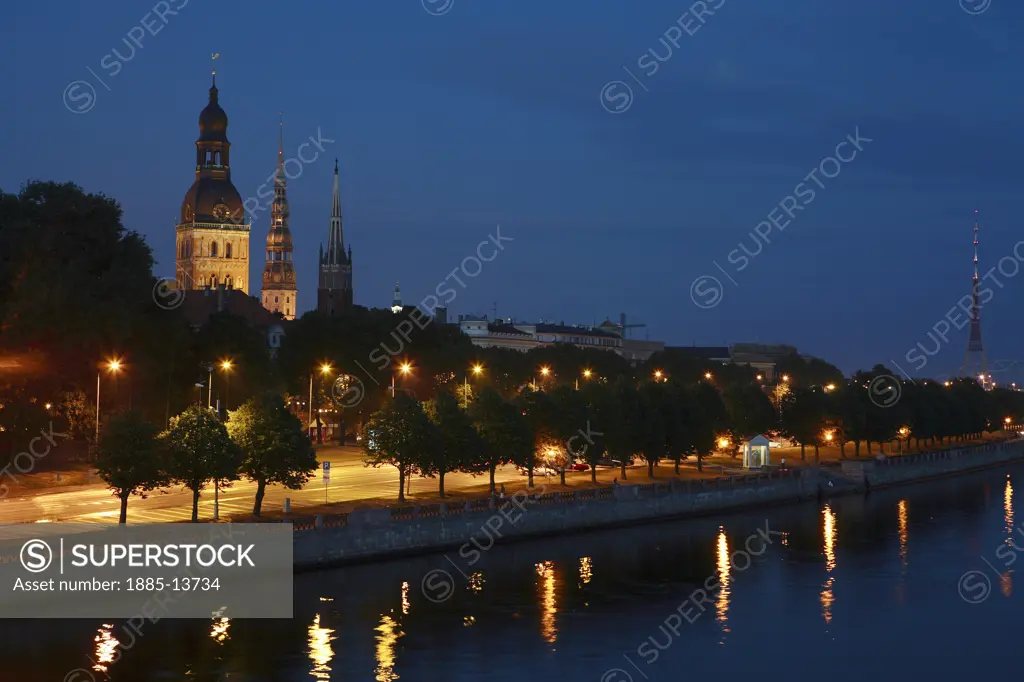 Latvia, , Riga, Daugava River with view of castle and churches at night