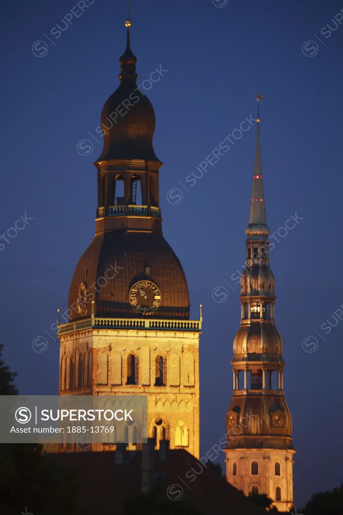Latvia, , Riga, Spires of Lutheran Cathedral and St Peter's Church in the Old Town at night
