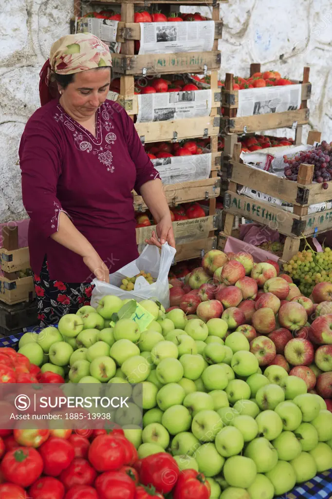 Turkey, Mediterranean, Fethiye, Stallholder and produce in the market