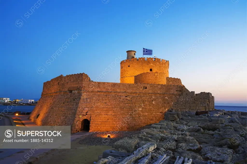 Greek Islands, Rhodes Island, Rhodes Town, Mandraki Harbour - castle at harbour entrance at dusk