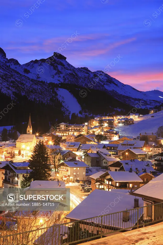 Italy, Trentino-Alto Adige, Arabba, Town and Dolomites at dusk in winter 