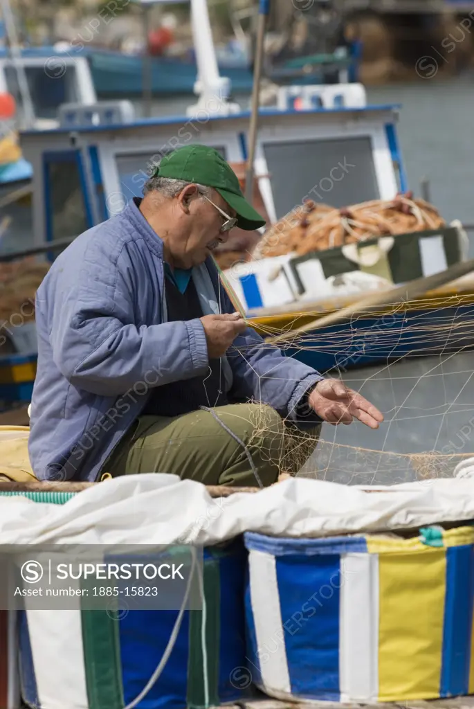 Cyprus, South, Potamos tou Liopetri, Fisherman mending nets