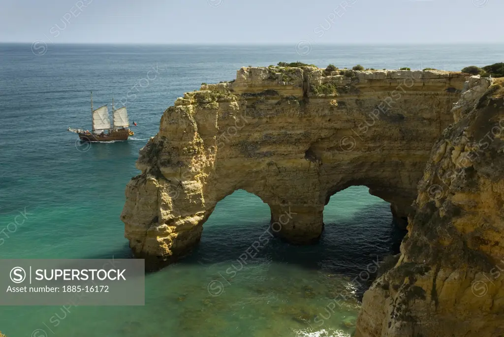 Portugal, Algarve, Praia da Marinha, Rock formations and sailing boat