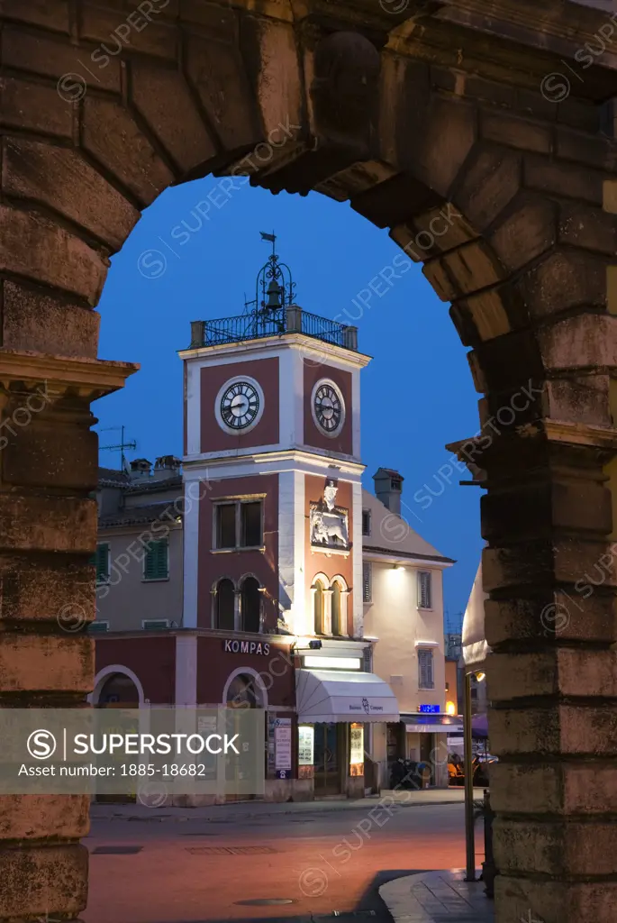 Croatia, Istria, Rovinj, The main square through Baroque archway at dusk