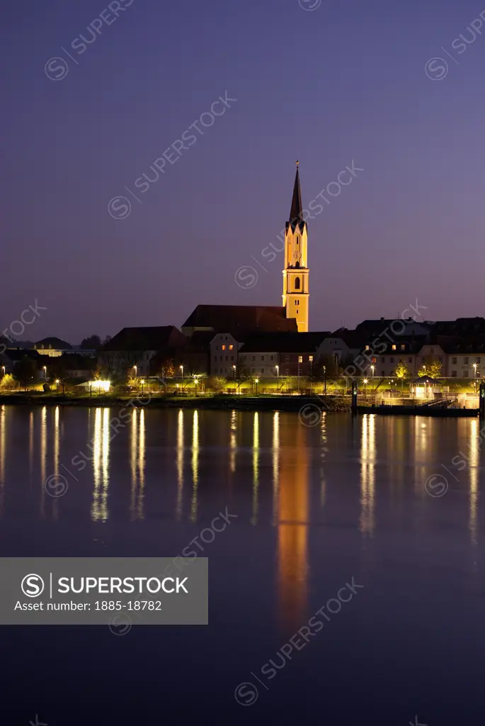 Germany, Bavaria, Vilshofen, Church of St John across Danube at night