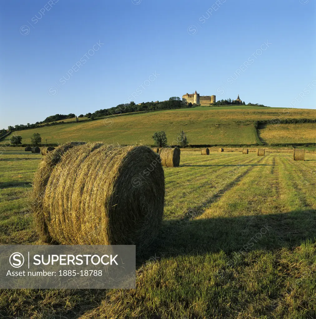 France, Burgundy, Chateauneuf, Hay bales below the chateau