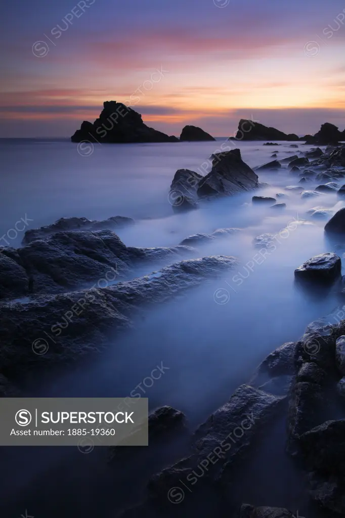 UK - England, Dorset, Mupe Bay, Mupe Rocks - sea stacks and rock ledges at dusk