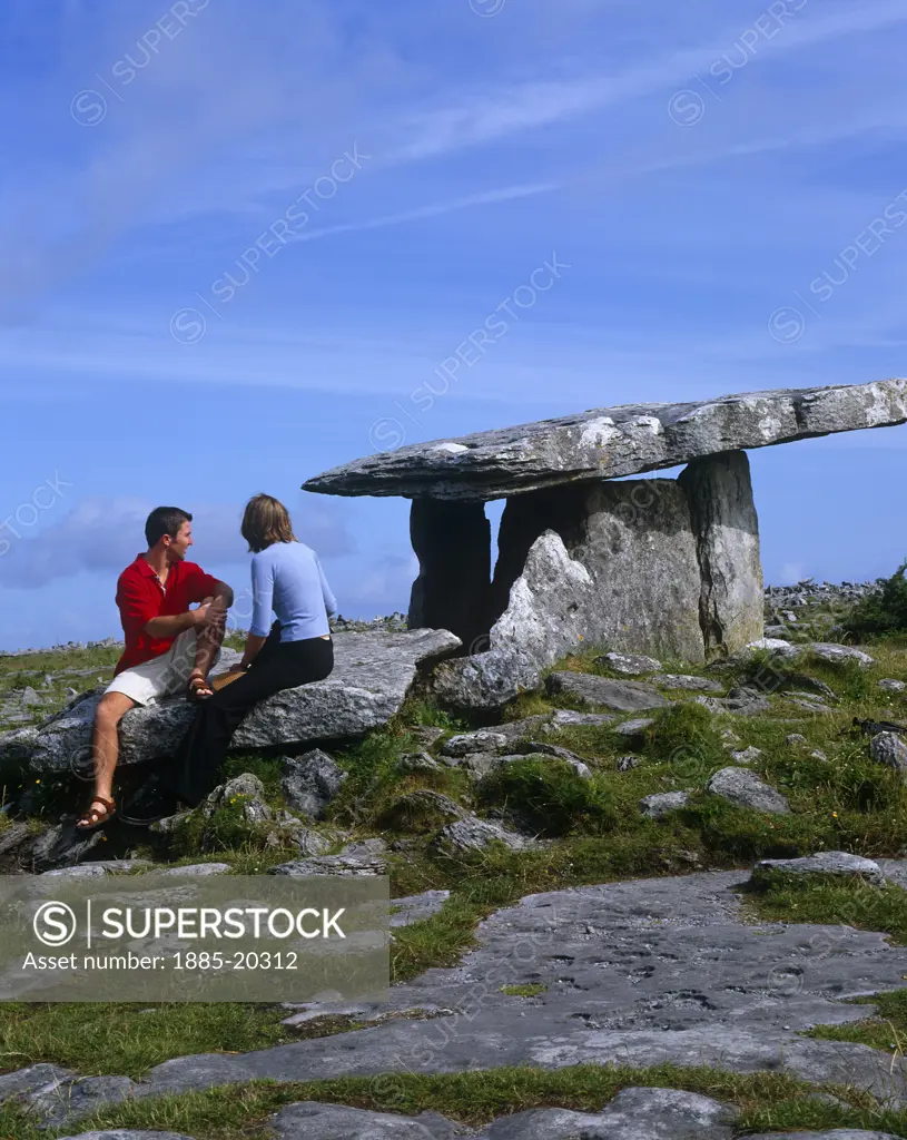 Ireland, County Clare, The Burren, Couple at Poulnabrone Dolmen