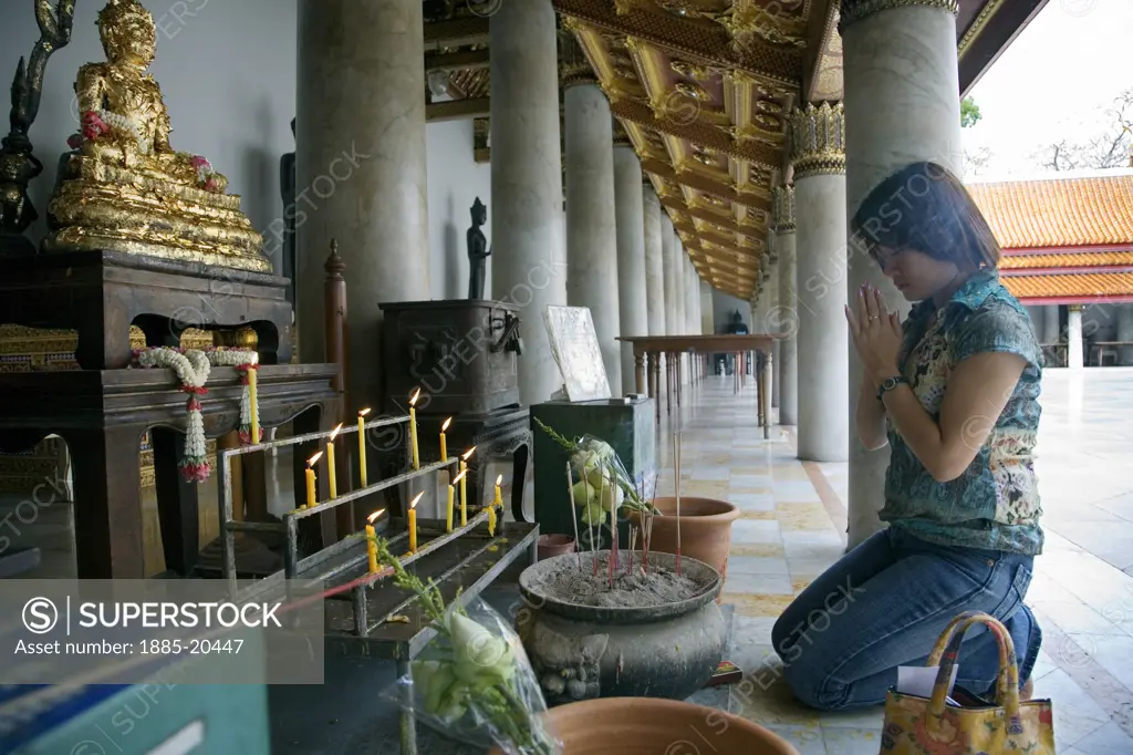 Thailand, , Bangkok, Wat Benchamabophit - worshipper at shrine