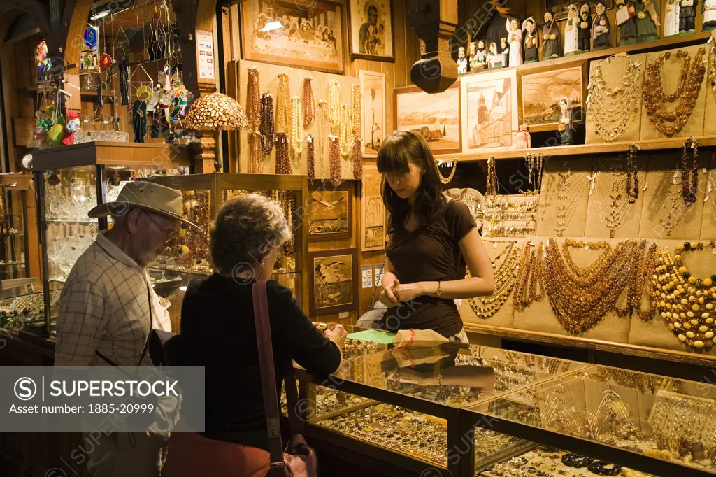 Poland, Krakow, Colourful market stalls selling amber jewellery inside the Cloth Hall or Sukiennice in Rynek Glowny