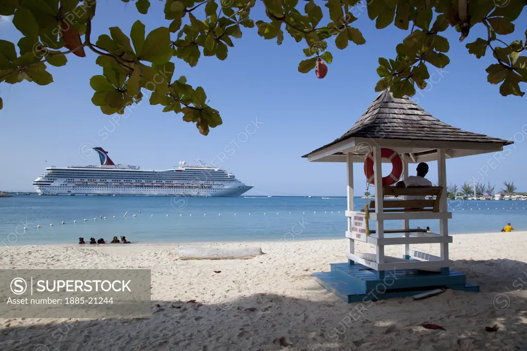 Caribbean, Jamaica, Ocho Rios, Beach with lifeguard tower and cruise ship