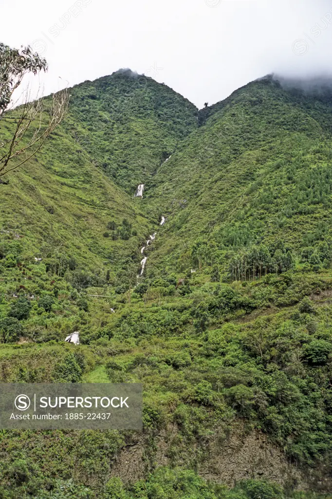 Ecuador, Forest  mountain terrain in Ecuador showing waterfall in distance