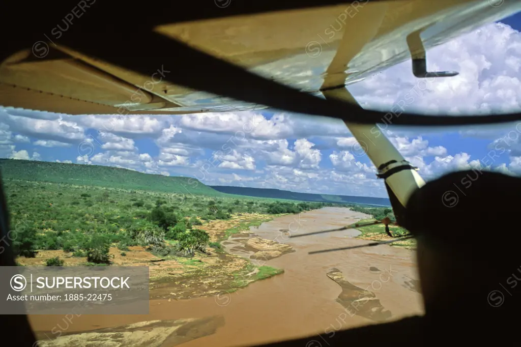 Kenya, Light Aircraft Flying over Tsavo River, Tsavo East National Park