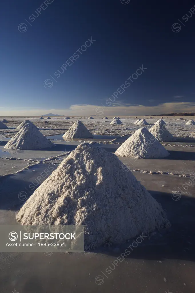 Bolivia, Piles of salt on the salar de uyini at dusk