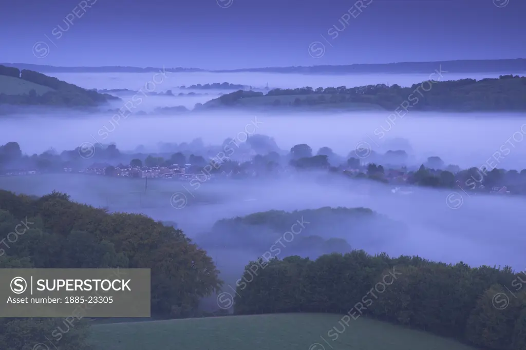 UK - England, Sussex, South Harting, Church and Village of South Harting rising out of the mist at dawn on the South Downs West Sussex