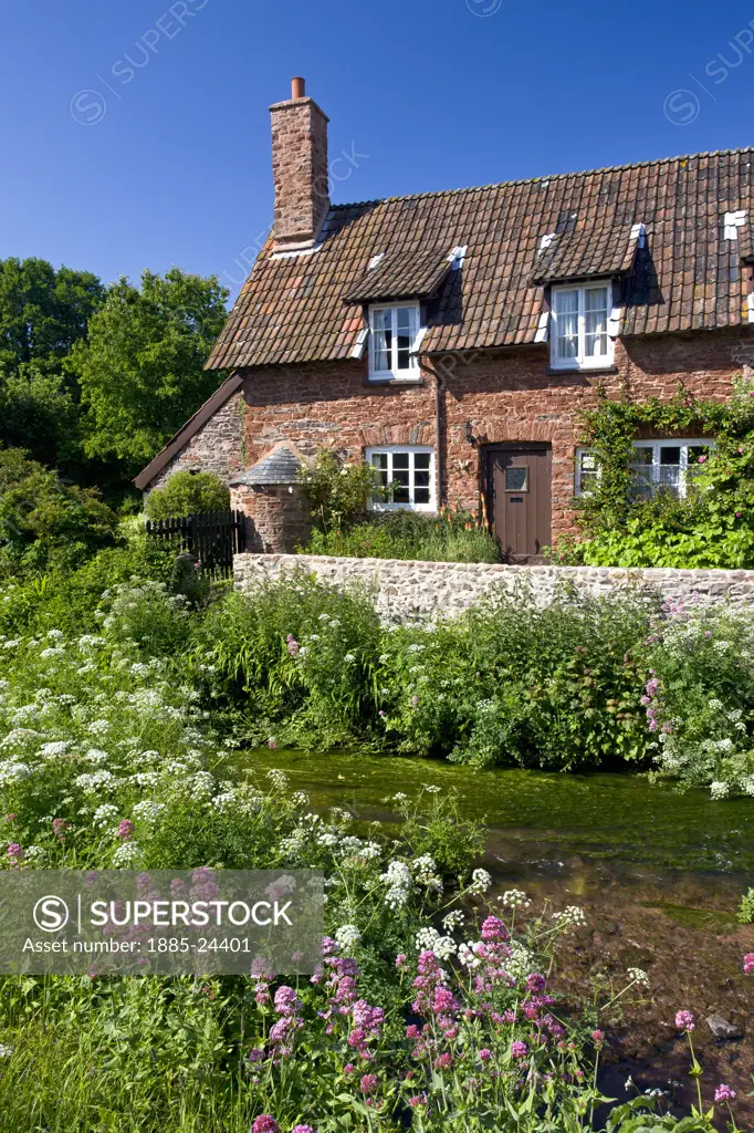 UK - England, Somerset, Allerford, Traditional cottage by the stream
