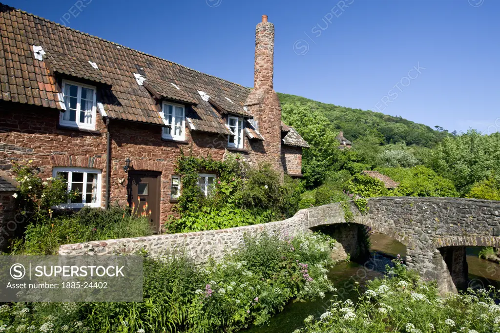 UK - England, Somerset, Allerford, Traditional cottage by the stream