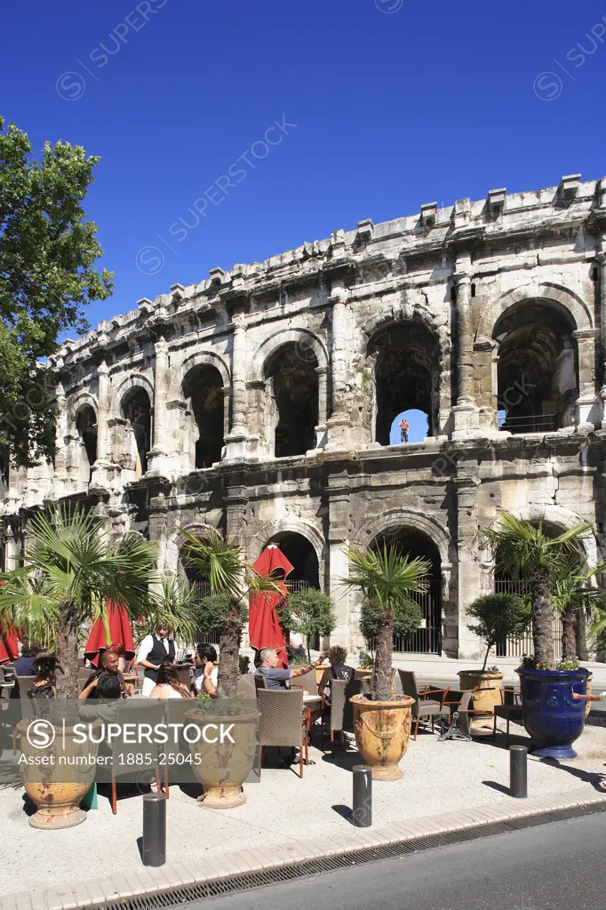 France, Languedoc-Roussillon, Nimes, Place des Arenes - amphitheatre and restaurants