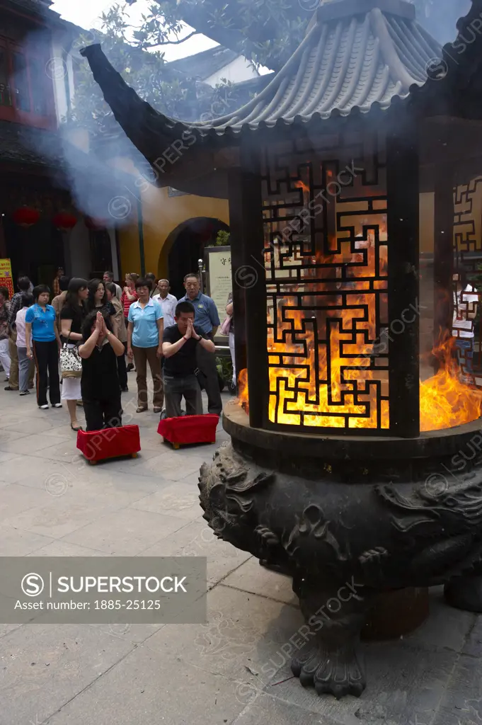 China, Shanghai, Burning paper money at the Jade Buddha Temple