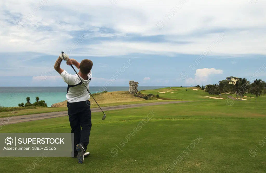 Caribbean, Cuba, Varadero, Golfer and ocean view at the Varadero Golf Club