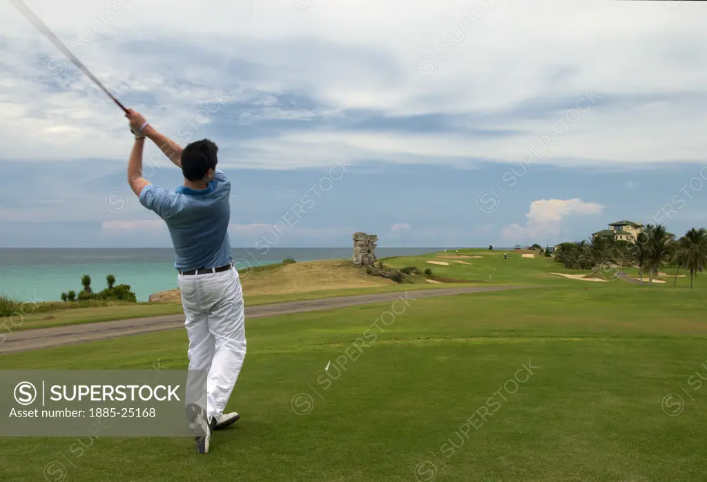 Caribbean, Cuba, Varadero, Golfer and ocean view at the Varadero Golf Club
