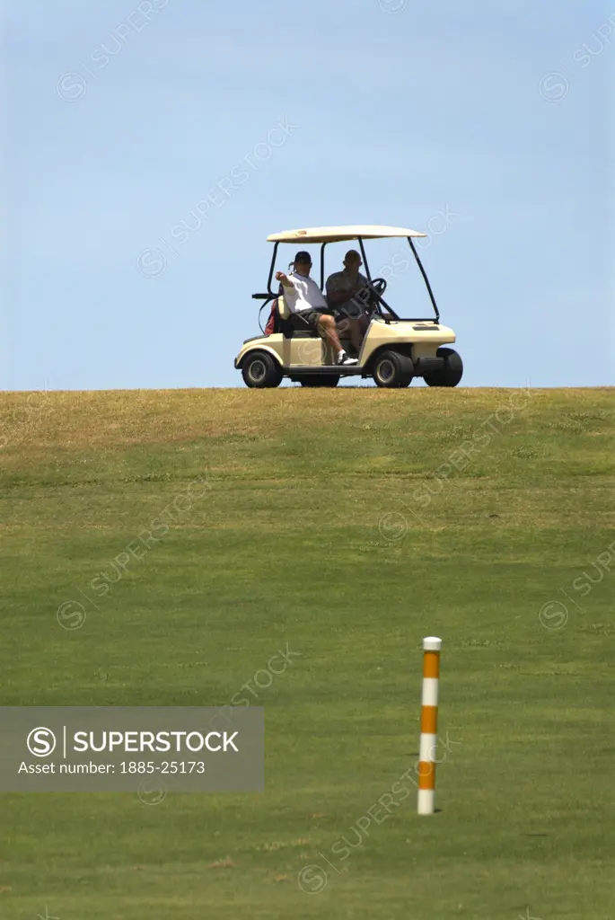 Caribbean, Cuba, Varadero, Golfers driving golf buggy at the Varadero Golf Club