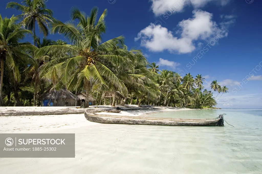 Panama, San Blas Islands, Tropical island with canoe on beach
