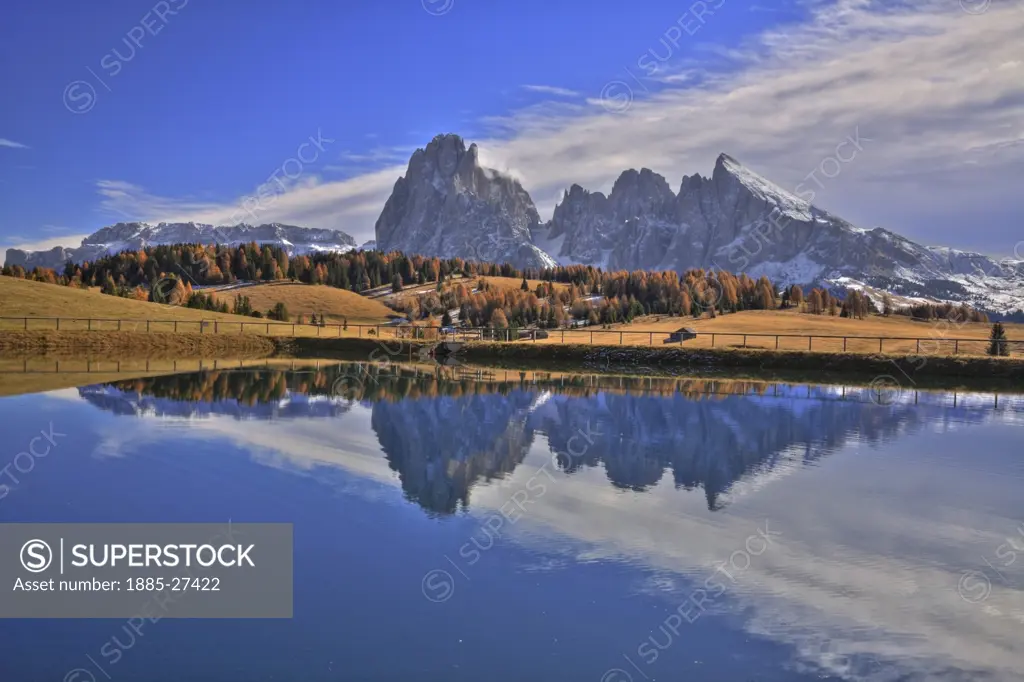 Italy, Italian Dolomites, Alpe di Siusi , Sasso Lungo and Sasso Piatto with reflections in lake