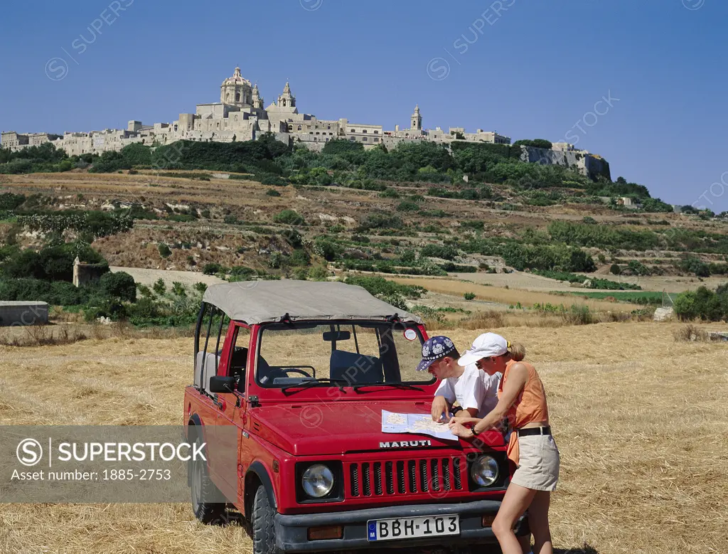 Maltese Islands, Malta, Mdina, Couple with Red Jeep in Field