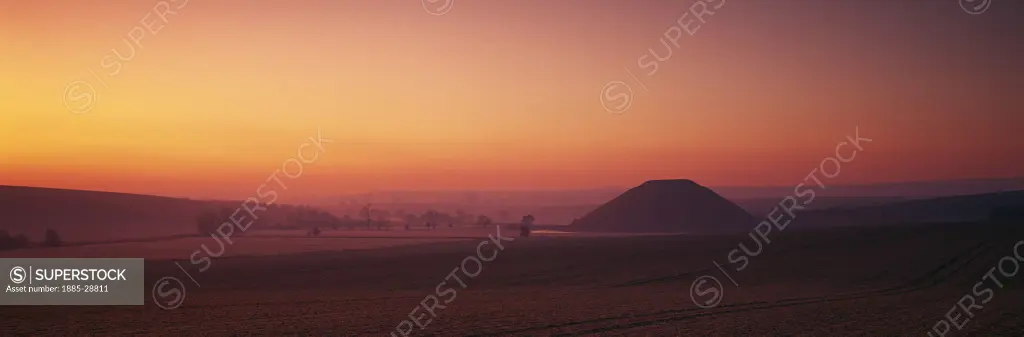 UK - England, Wiltshire, Avebury, Silbury Hill at dawn in winter