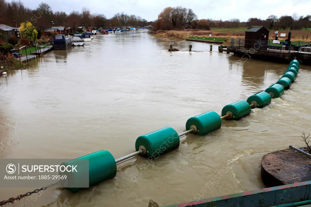Image of a debris collection boom, Flooded river Nene at Orton Mere lockgate sluices, Peterborough, Cambridgeshire, England, UK
