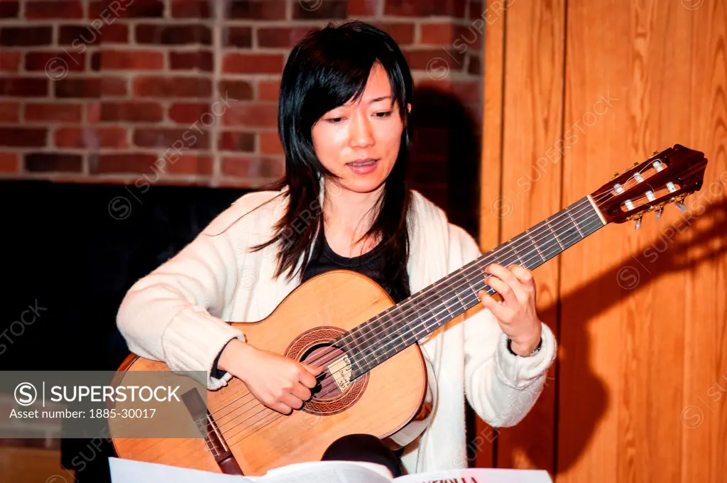 Xuefei Yang playing guitar during rehearsals at the Turner Sims Concert Hall in Southampton, Hampshire, England