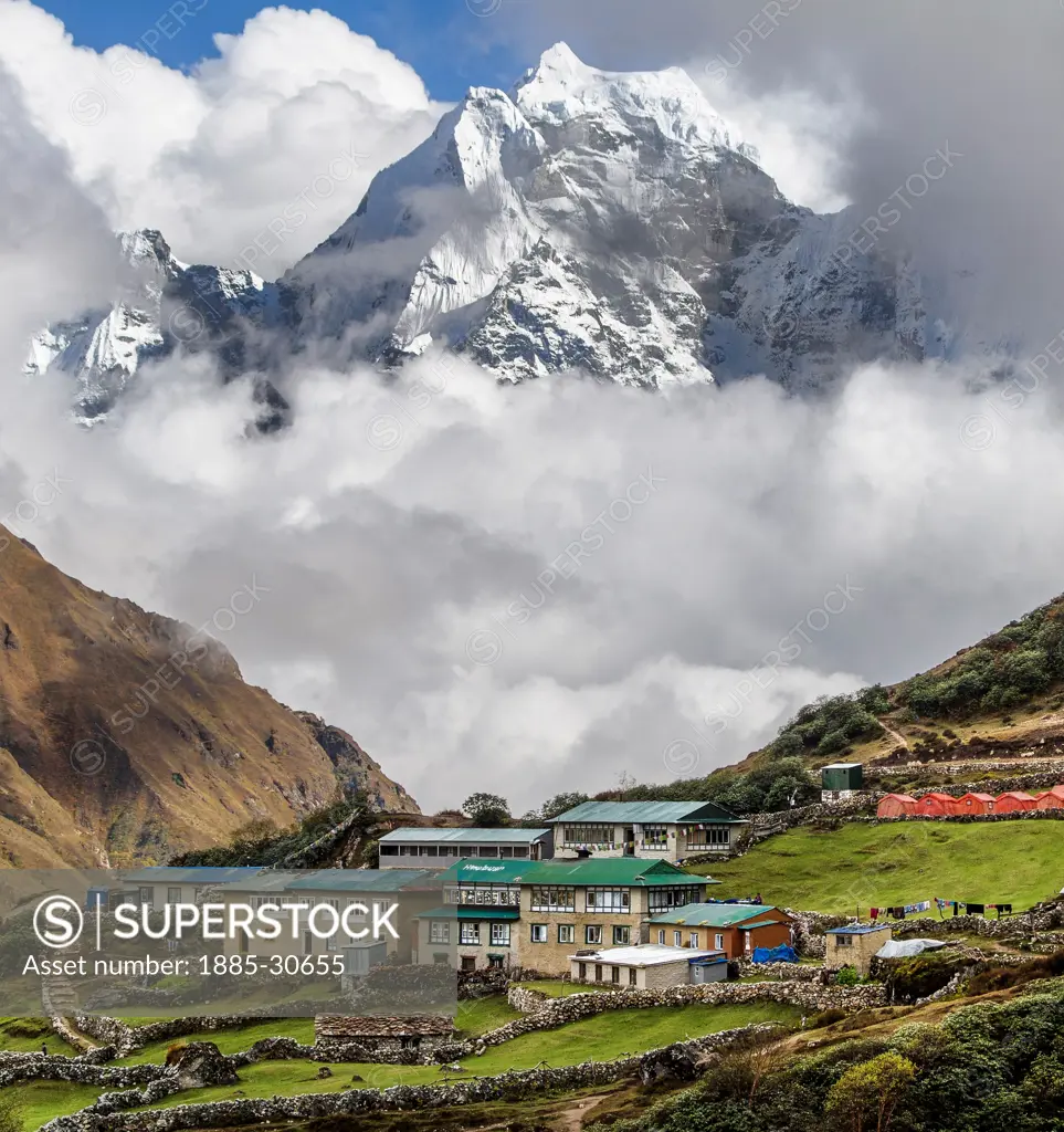 The small village of Dole (pronounced dough-lay) is perched along a sloping hill in the Ngozumpa glacier valley. This viewpoint is obtained after about a week of trekking and another day to the North brings trekkers out of the treeline altogether. Clouds often form in the late afternoon and patience rewards the prepared photographer.
